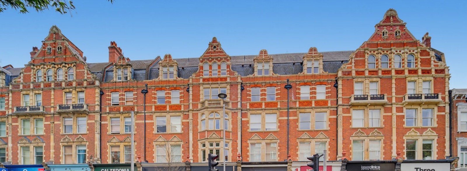 Red-brick mansion block on Kensington High Street, upper floors