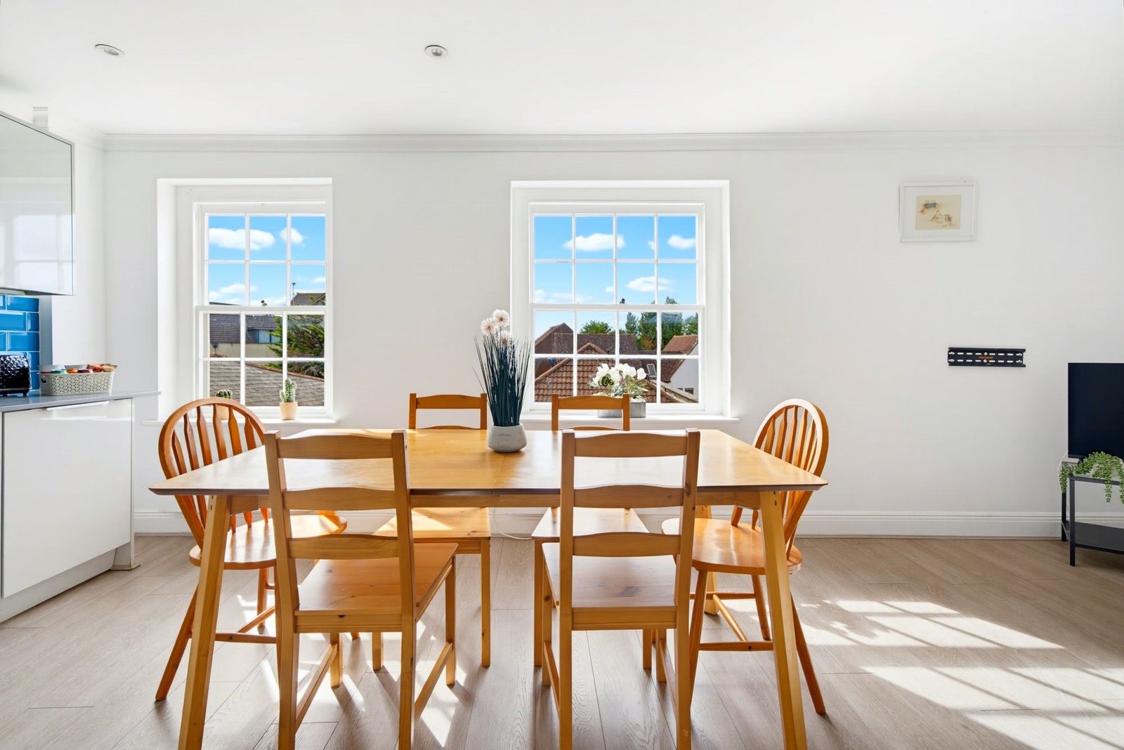 Dining table under tall sash windows