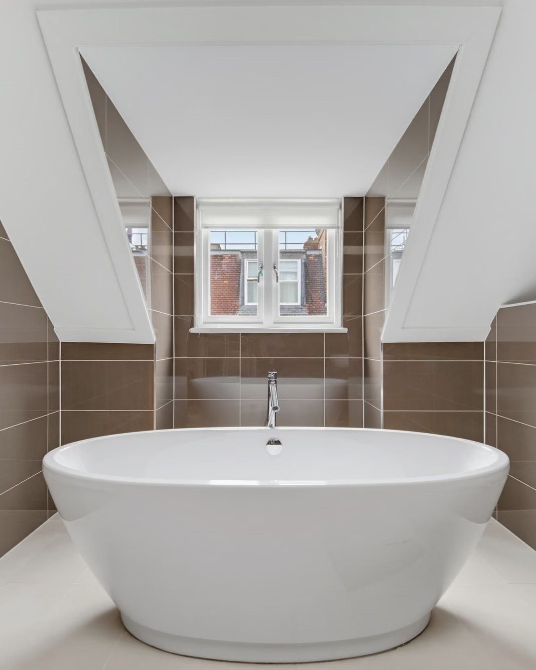 Freestanding bath beneath a dormer window
