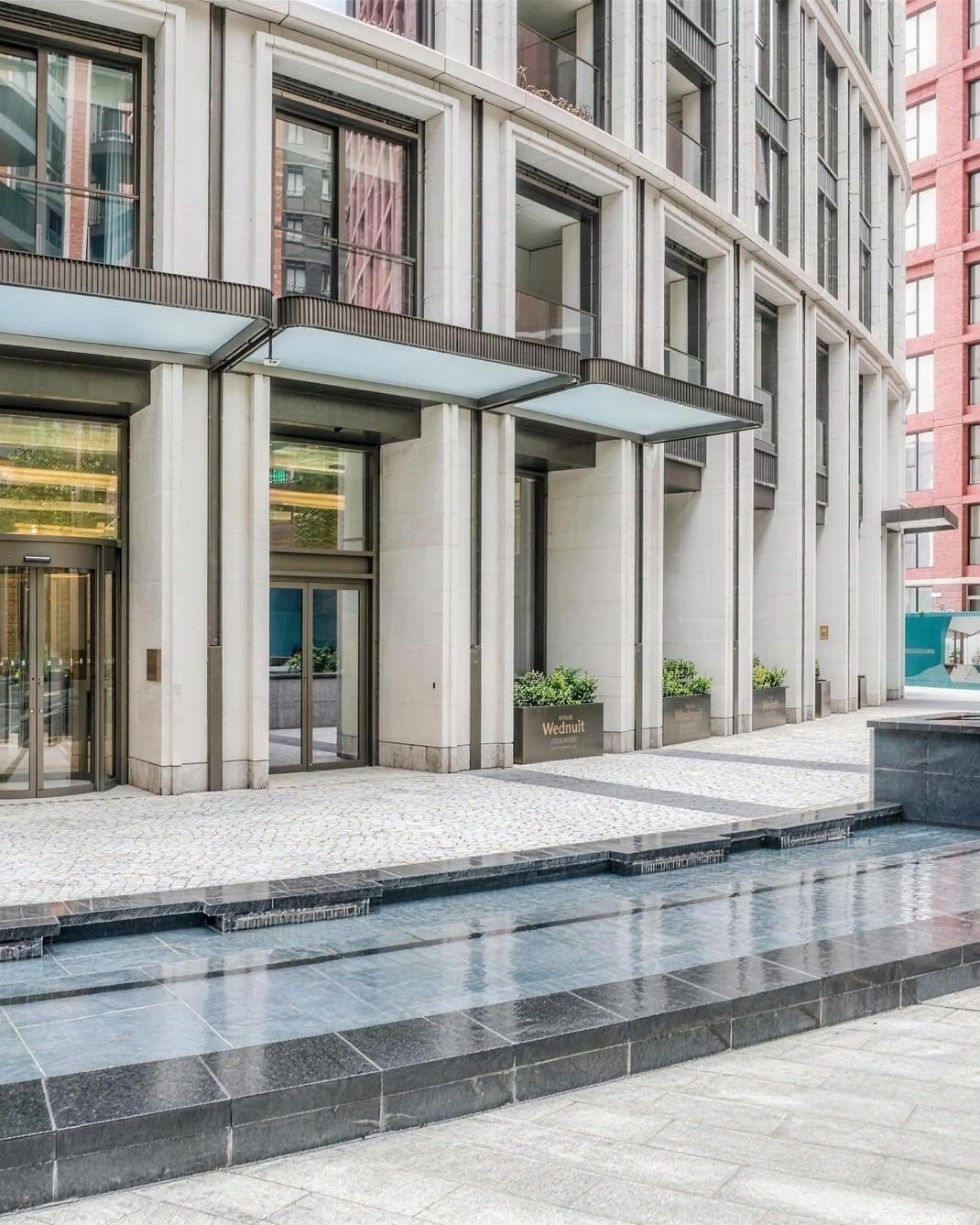 Stone building entrance with a still water feature, Paddington